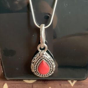 Embossed silver tone vintage pendent with coral center